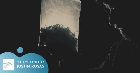 man in the dark carrying a bag of drugs