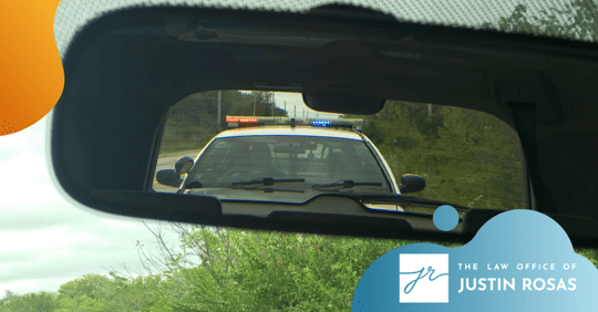 police car in rearview mirror
