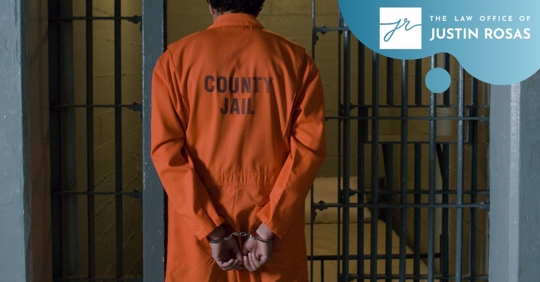 man in prison suit walking into cell