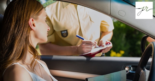 woman stopped by police, police officer taking notes at her window