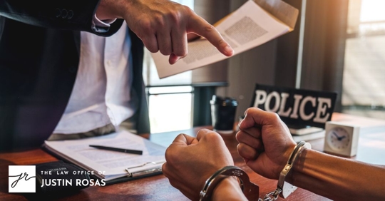 lawyer talking a man in handcuffs